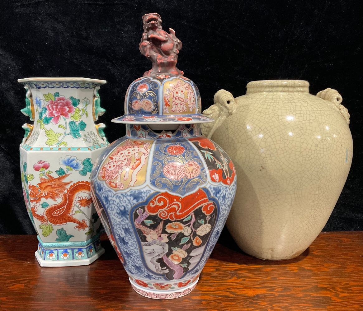 A large Japanese Imari ovoid jar and cover, painted with panels of fanciful birds, flowers and