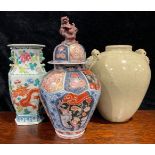 A large Japanese Imari ovoid jar and cover, painted with panels of fanciful birds, flowers and