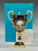 A Coalport three handled pedestal vase, The Iron Bridge Bicentenary, printed and hand painted