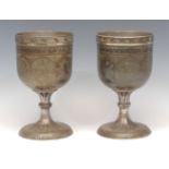 A pair of large Indian bidri pedestal goblets, each chased with stylised lotus, 21.5cm high