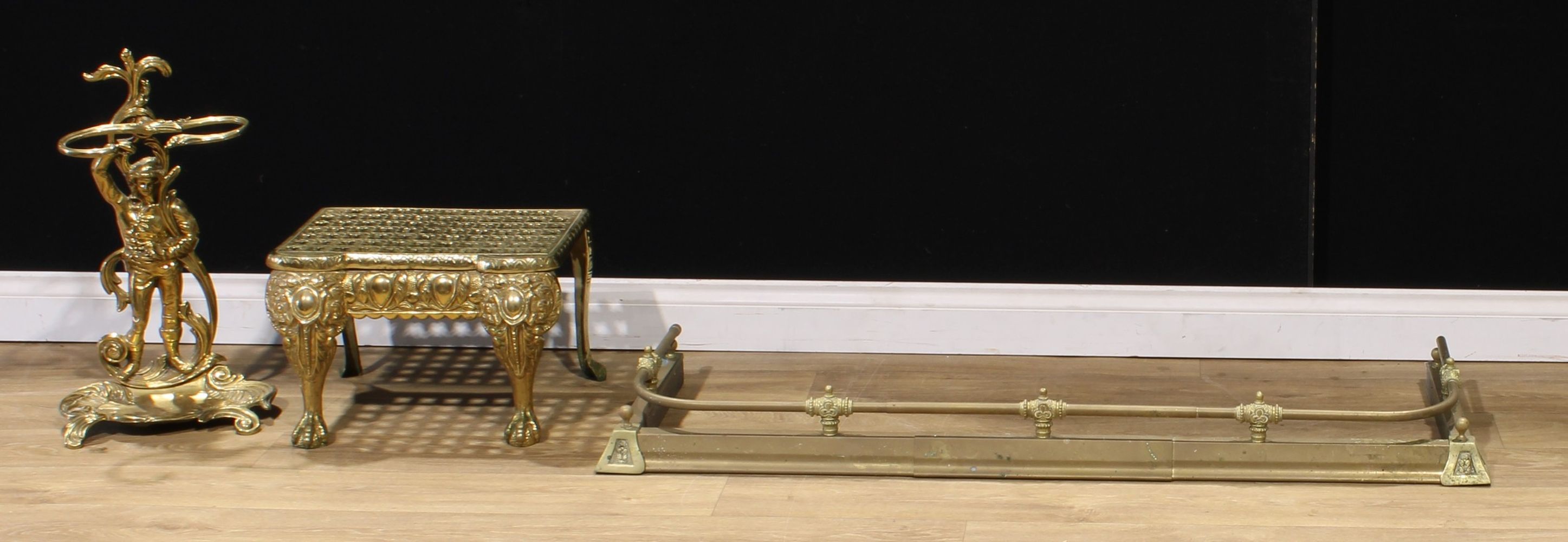 A 19th century style brass walking stick stand, 59cm high; a brass extendable fire curb or fender,