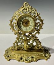 A Victorian ornate brass cherub mantel clock