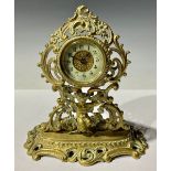 A Victorian ornate brass cherub mantel clock