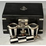 A pair of contemporary opera glasses, chequered pattern, in metal bound box