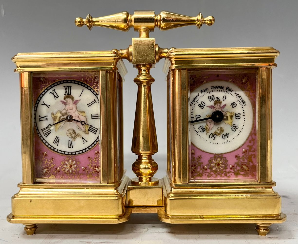 A French style lacquered brass double carriage clock and barometer, applied with printed and painted
