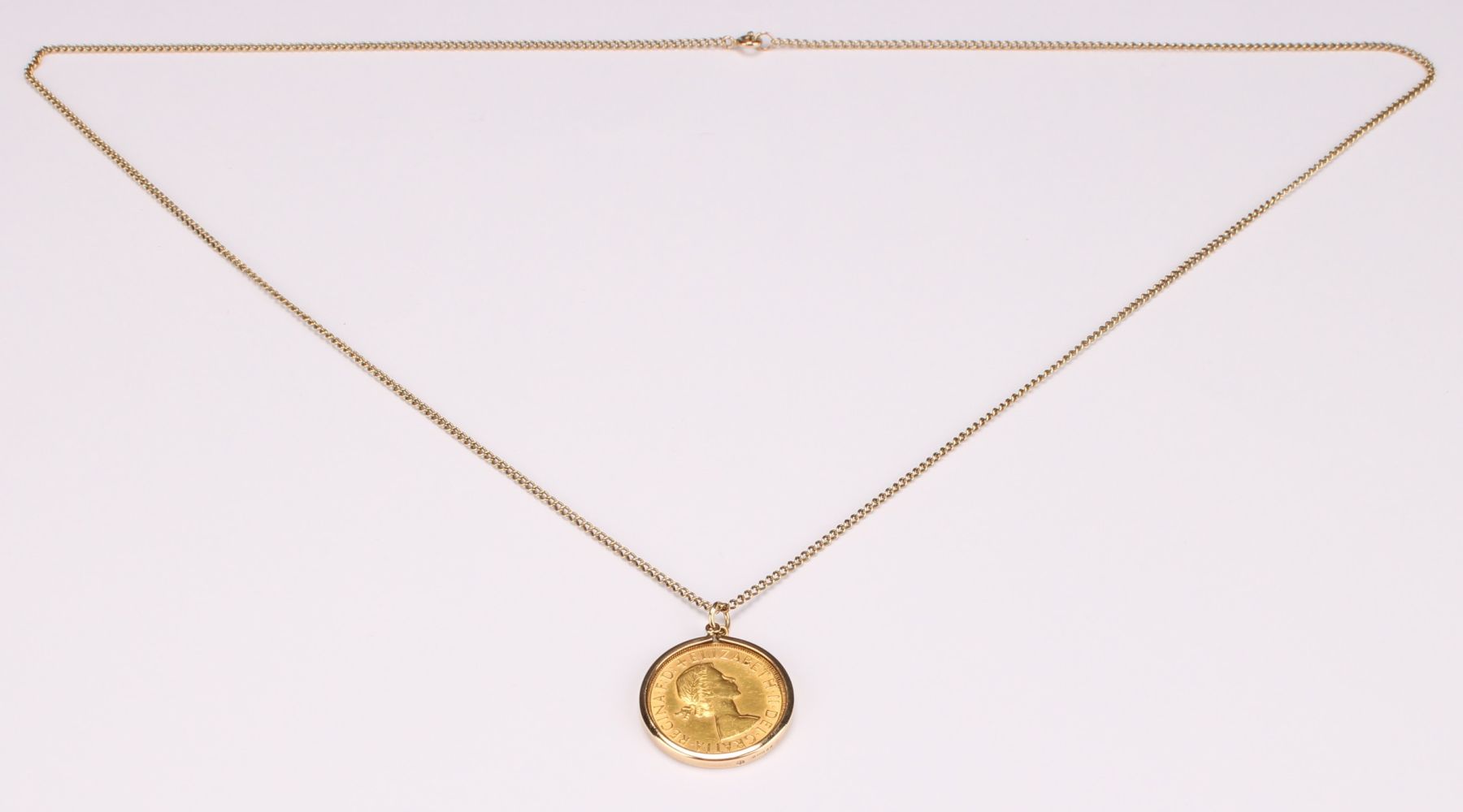 An Elizabeth II full gold sovereign, 1963, 9ct gold mounted as a pendant with 9ct gold necklace