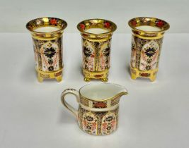 A pair of Royal Crown Derby 1128 Imari pattern miniature cylindrical vases, four slightly splayed