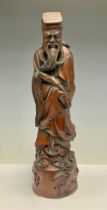 A Chinese carved wooden figure, as an elder, 38cm high