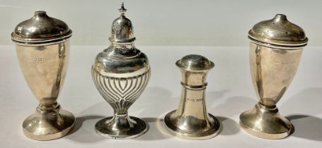 A silver pepper and salt, Birmingham 1932; two other peppers, Birmingham 1944 and Sheffield 1923,