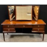 A Stag mahogany dressing table, triple mirror, arrangement of five drawers to base, 128cm high x