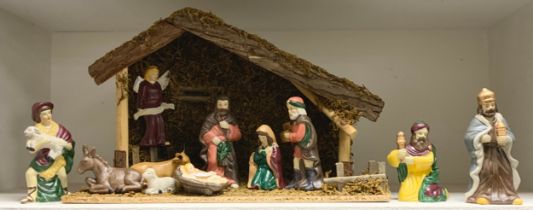 A continental hand painted porcelain nativity scene with figures, animals and a conforming barn