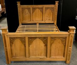 A Gothic style pine King-size bed, 142cm high at headboard x 228cm x 171cm overall (200cm x 153cm