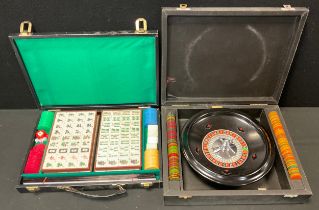 Games - a cased K & C London roulette set with metal wheel, assorted chip counters; cased and sealed