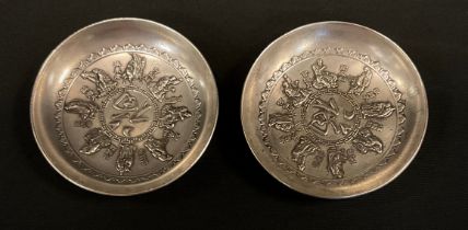 A pair of Chinese white metal coin dishes, 8.6cm diameter (2)