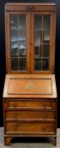 An early 20th century Jacobean Revival oak bureau bookcase, lead glazed, c.1930