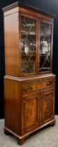 A George III style mahogany Secretaire bookcase, dentil cornice, astral-glazed doors enclosing two