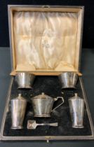 An Art Deco silver five piece condiment set, pair of open salts, pair of pepperettes and lidded