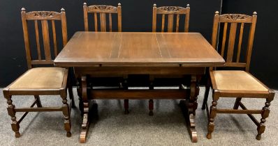 An Ercol oak draw-leaf trestle dining table, and set of four dining chairs, the table measuring 74cm