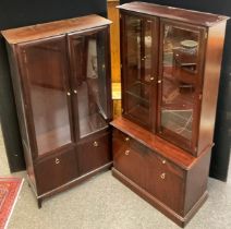 A Stagg Minstrel two door display cabinet, 3/4 length glazed doors over pair of cupboard doors,