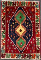 A South-west Persian Qashgai rug, hand-knotted with a central row of three diamond-shaped