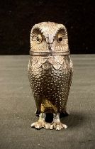 A Novelty silver coloured metal pepper pot, as an Owl, 8cm high