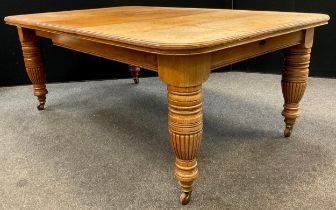 A Victorian oak extending dining table, rounded rectangular top, with single additional leaf,