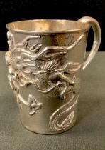 A Chinese silver cup possibly by Wang Hing, the sides finely relief decorated with a dragon on