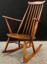 An Ercol Goldsmiths Windsor rocking chair, c.1960, 87cm high.