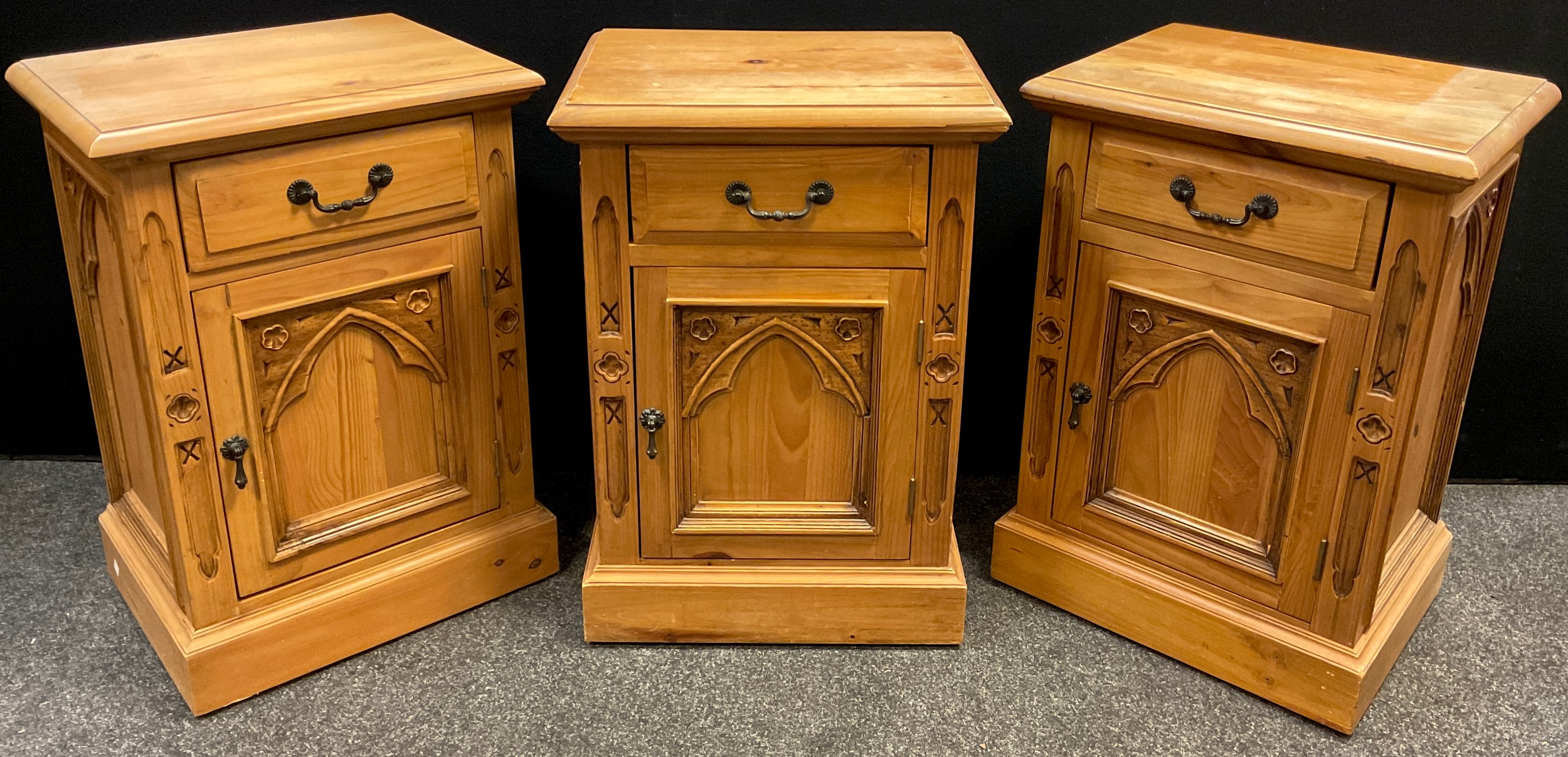 Three pine gothic style bedside cabinets, each with a single drawer to frieze, above a single