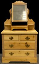 A pine dressing chest, dressing mirror top with shaped supports and three small shelves, above a