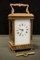 An early 20th century carriage clock, ornate banded case, white dial, bold Roman numerals, 16cm high