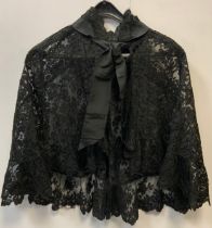 A Victorian black lace shoulder piece/cape all over decorated with floral vines and panels, jet