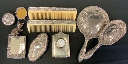 A Concorde silver travel clock, R Carr, Sheffield 1995; silver topped cut glass Dressing table tidy,