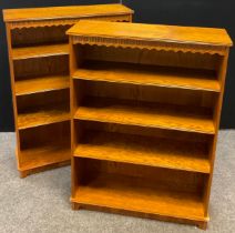 A pair of oak veneered open bookcases, four tiers of shelving to each, 134cm high x 97cm high x 32cm