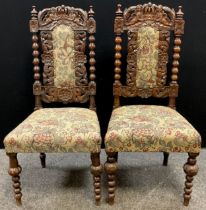 A pair of Victorian Carolean Revival oak hall chairs, c.1880