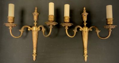 A pair of brass two branch wall lights, 36.5cm high, 31cm wide.