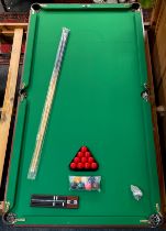 A Pot Black snooker table, two cues, balls etc 183cm x 91.5cm.