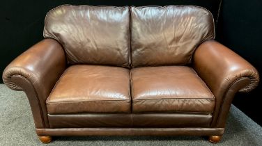 A bespoke made Italian tan leather two seat sofa, 98cm high x 182cm wide x 99cm deep.