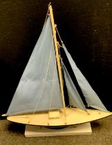 A model pond yacht and stand