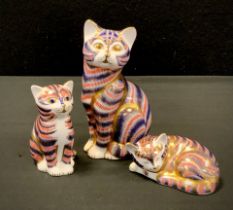 A group of three Royal Crown Derby cats including; large cat 13cm high, smaller 8cm high, sleeping