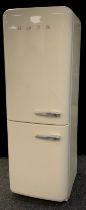 A freestanding smeg fridge freezer in cream with left-hand hinge. Model no. S32STRP3, serial no.