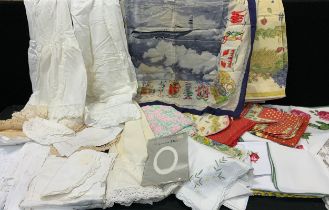 A quantity of linen including table linen, printed fabric, lacework, skirts, Victorians later