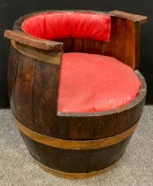 A large oak barrel converted for use as a garden seat, 68cm high x 66cm wide.
