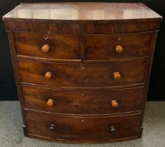 A Victorian mahogany bow-front chest of drawers, two short, over three graduated long drawers,