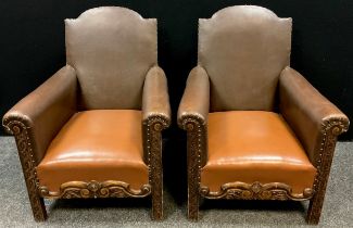 A pair of Arts and Crafts style carved oak and leatherette armchairs, 88.5cm high x 72cm wide x 70cm