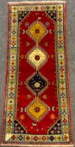 A South-west Persian Qashgai runner carpet, hand-knotted with a row of four hexagon-shaped