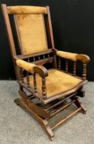 A late 19th / early 20th century American style walnut rocking chair, 101cm high x 54.5cm wide x