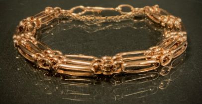 A 9ct gold fancy link gate bracelet, 8mm wide, 15g gross