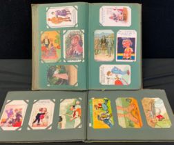 Two Edwardian and later postcard albums mostly humorous and risqué cards inc Donald McGill, Reg