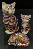 A group of three Royal Crown Derby cats including large cat, 13cm, sitting kitten, sleeping